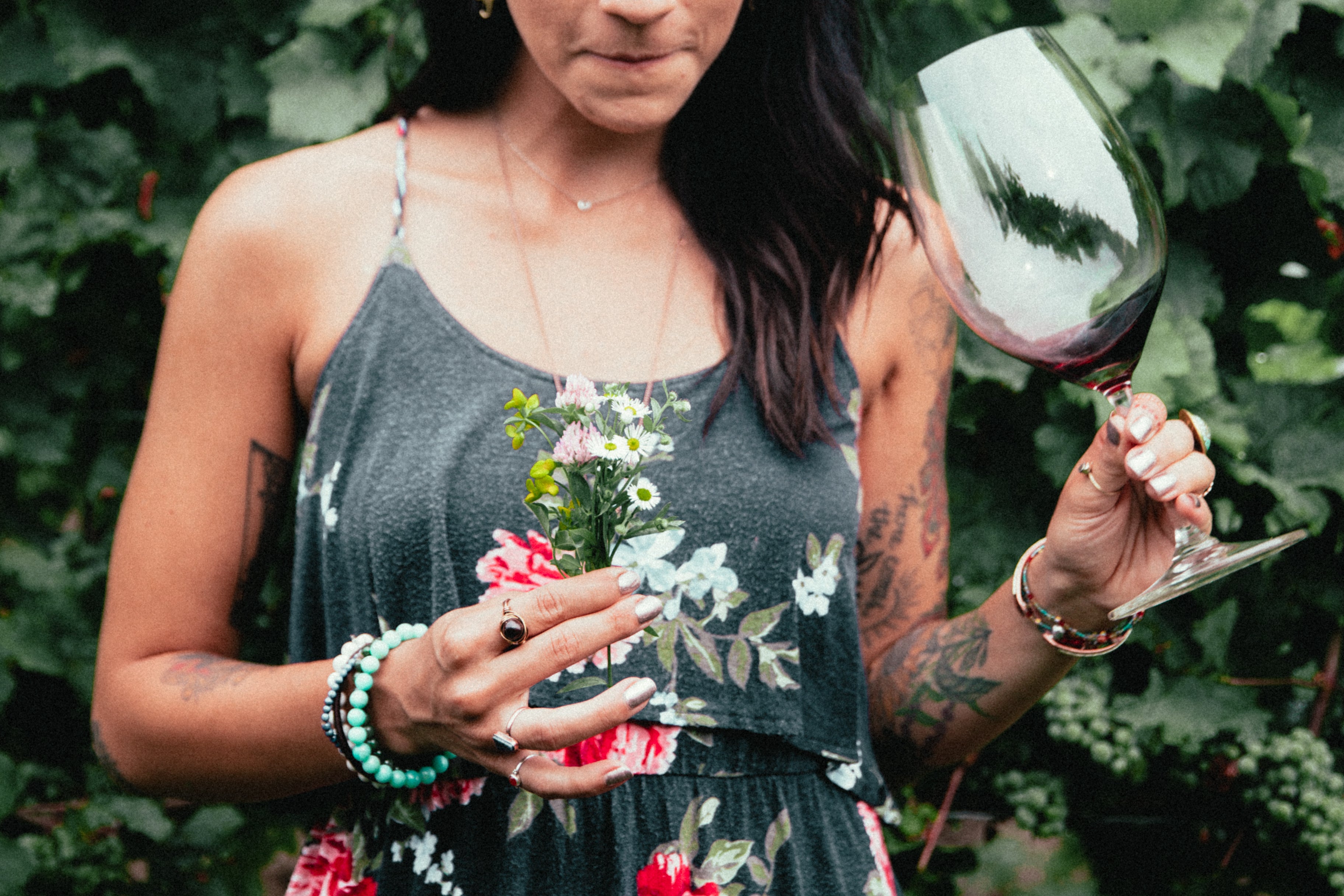 files/womens-fashion-tattooed-woman-holding-flowers-and-wine.jpg